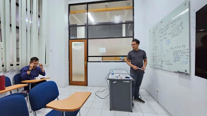 A person standing in front of a whiteboard
Description automatically generated